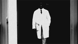 Evil doctor under a dark doorway